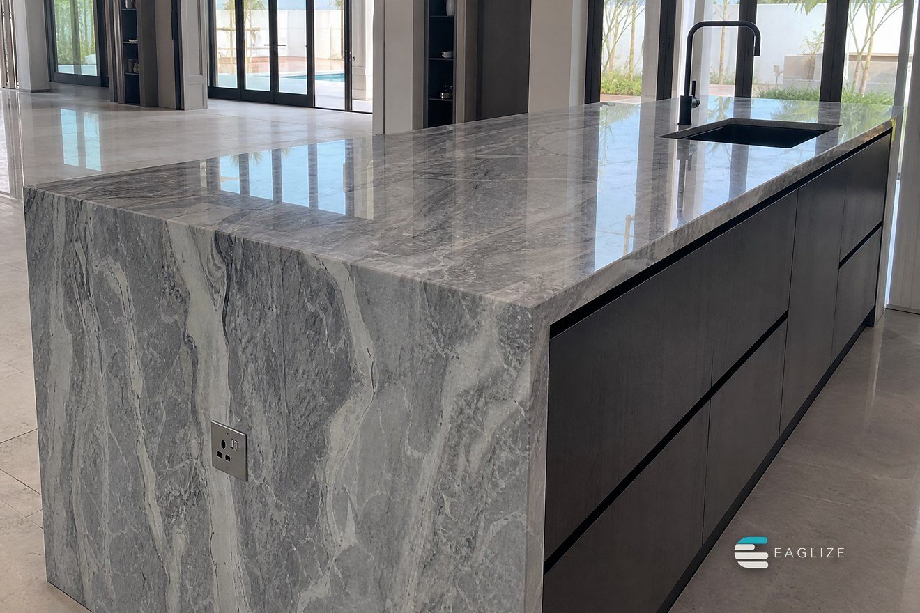 Mitred stone worktop with a waterfall end over a handleless dark timber run
