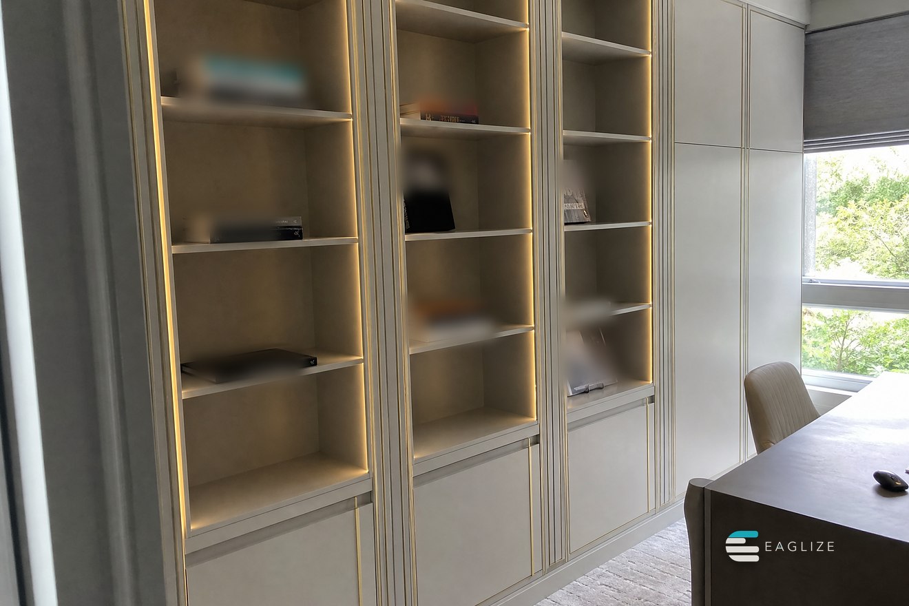 Study wall with lit open shelving, slim reveals and full height closed storage alongside